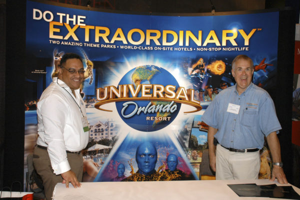 Two Men in Front of Universal Orlando Poster
